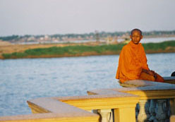  Monk on banks of Tonle Sap River, Phnom Penh, Cambodia
